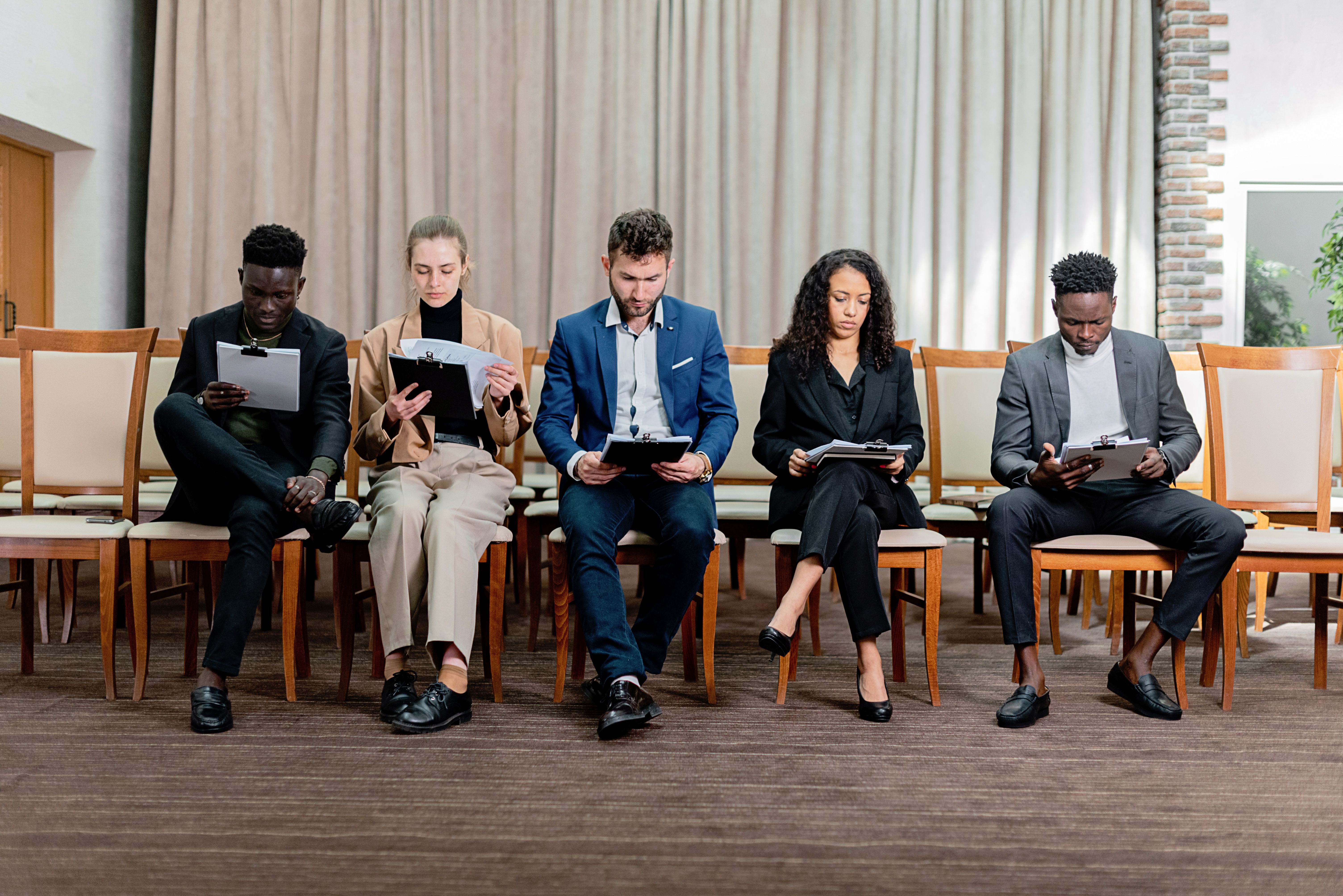 Women Sitting on a Sofa While Talking Business